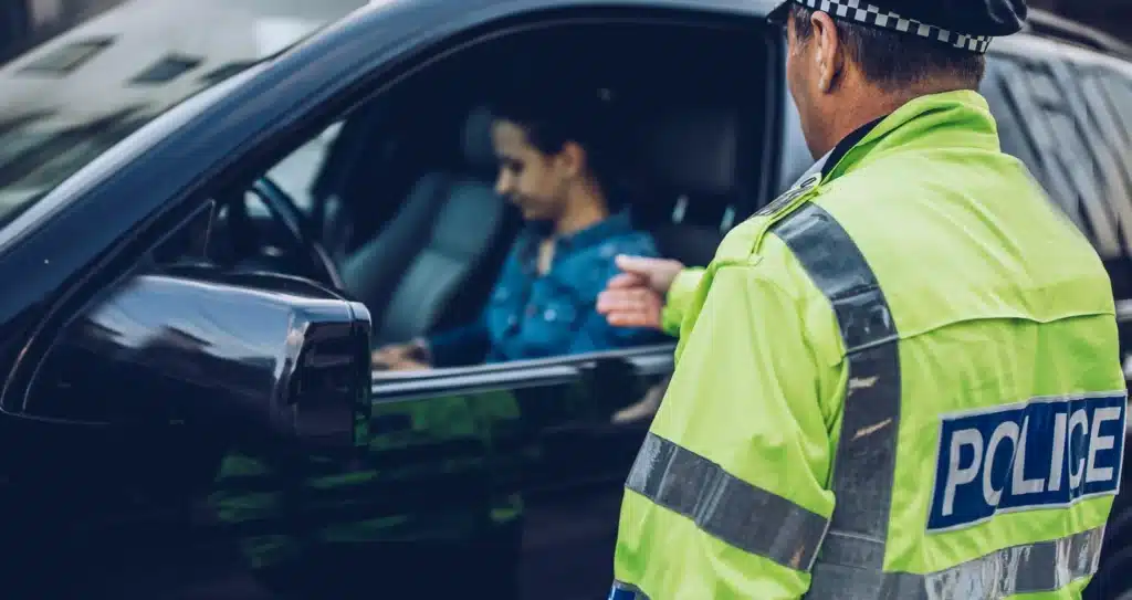 A Calgary policy officer pulls over a person driving without insurance.