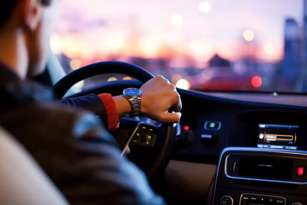 A person driving a car in downtown Calgary without car insurance.