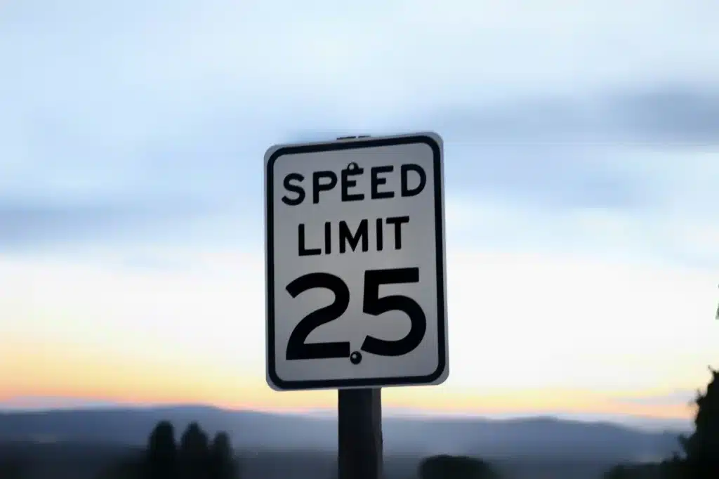 a speed limit sign on the side of the road