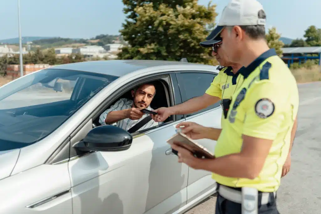 A police team gives a traffic ticket to an out of province driver.