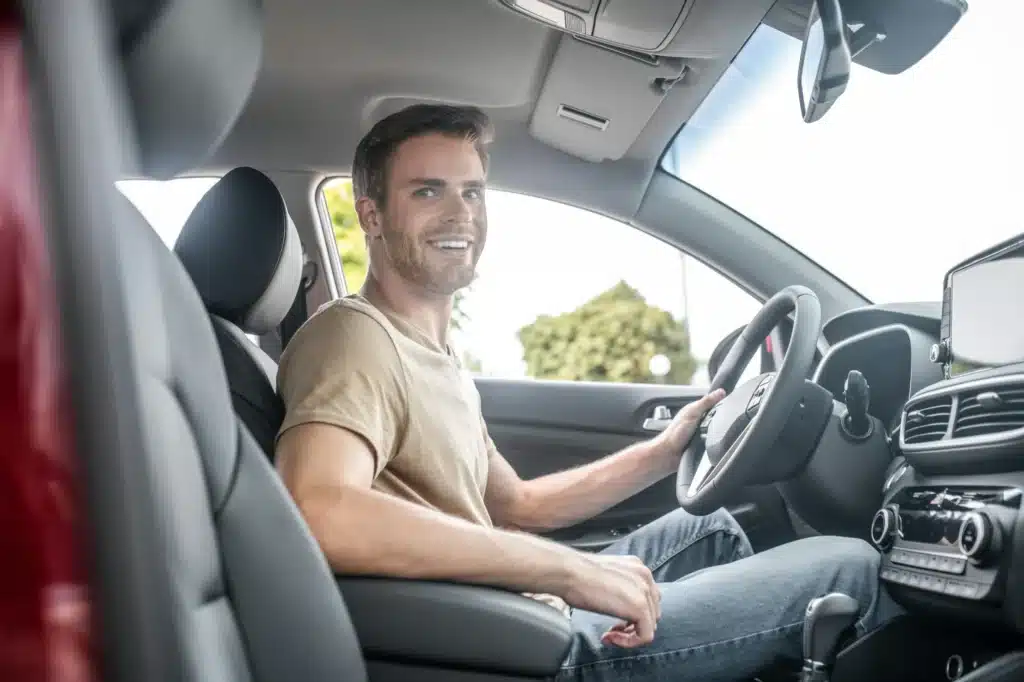 A happy driver smiles after fighting their traffic ticket and winning in Alberta.