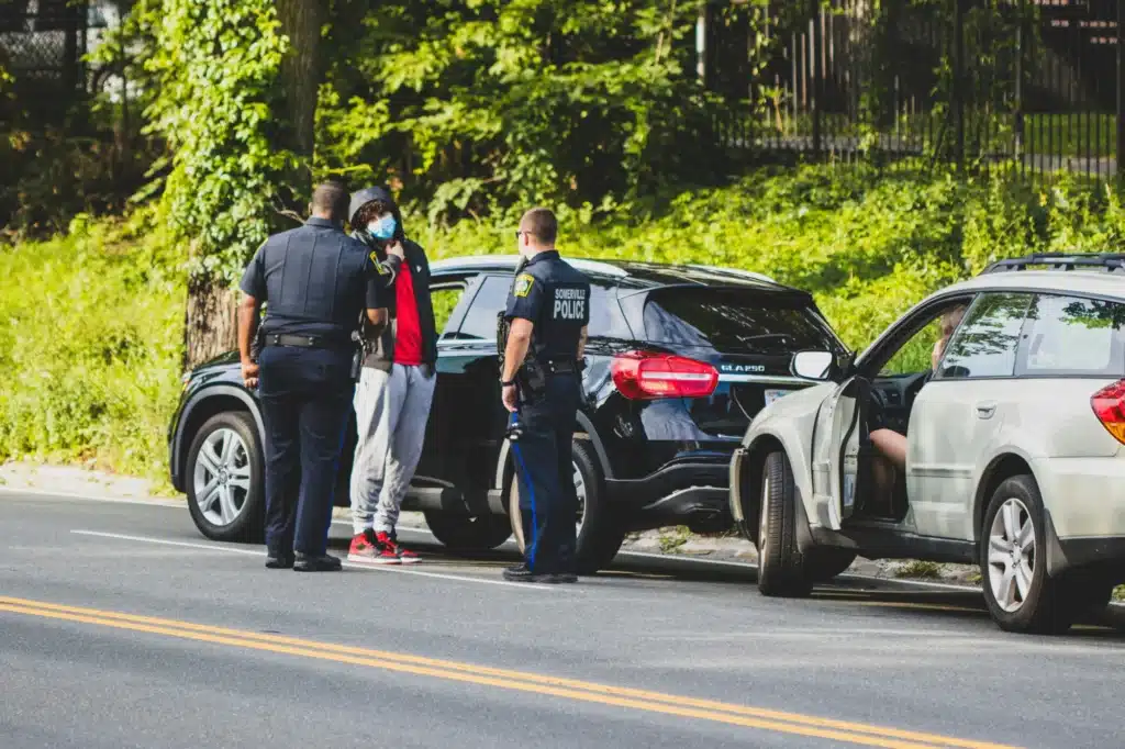 A victim in a car crash talks to the police on the side of the road in Calgary.