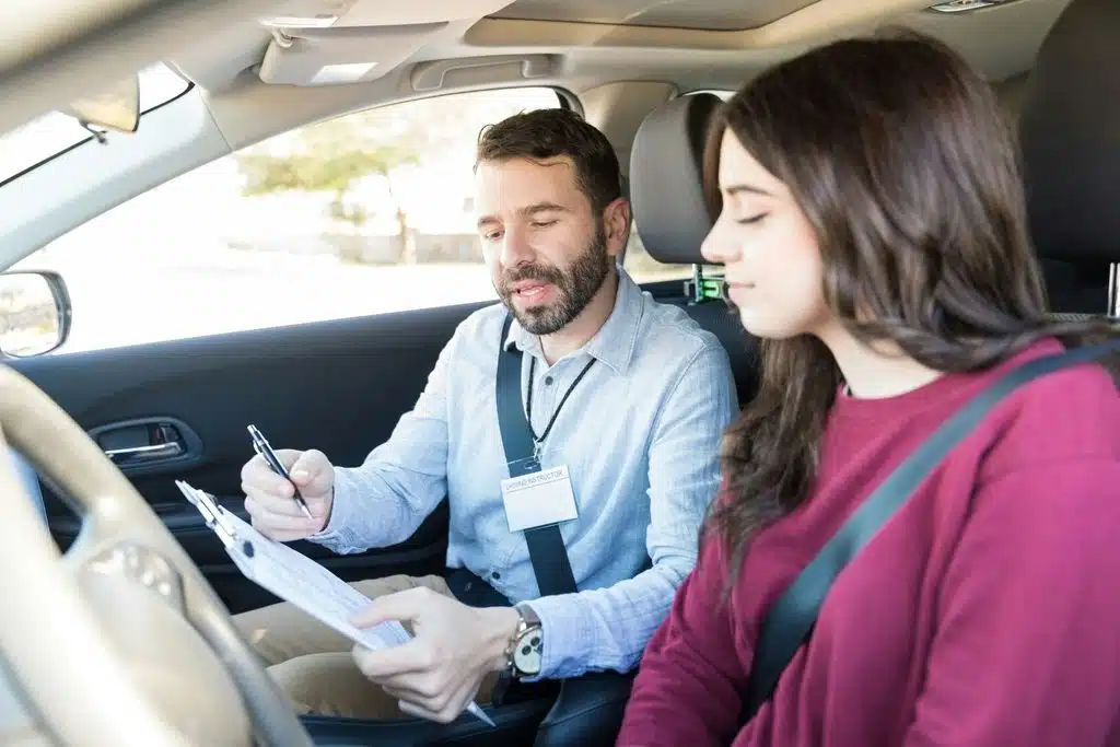 A driving instructor explains the importance of following the rules of the road and how to avoid getting demerit points to a new driver in Calgary.