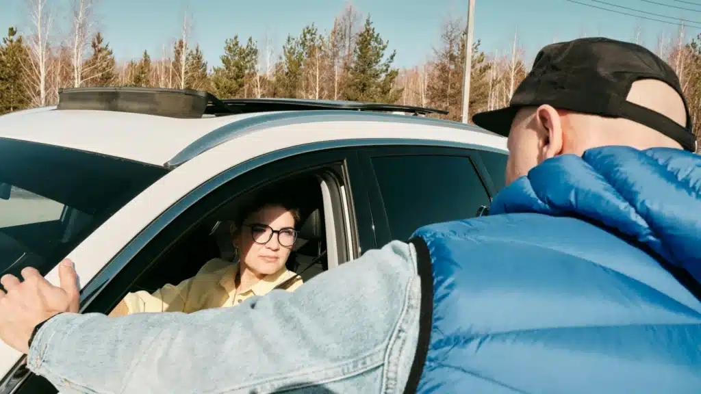 A car owner talks to their friend who is borrowing their car.
