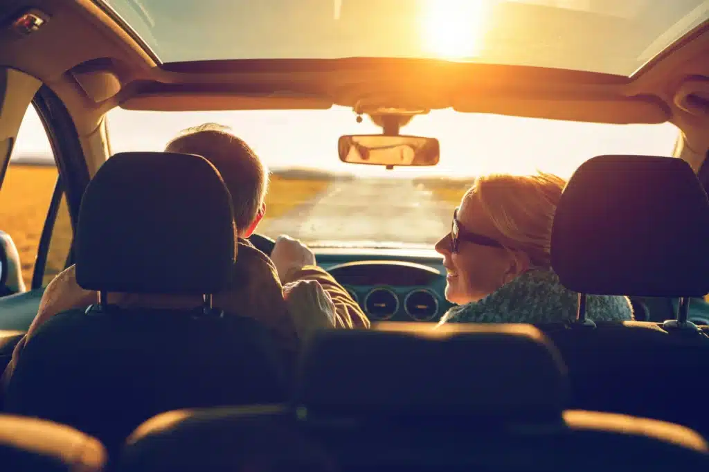 Two people drive into the sunset after successfully fighting their traffic ticket.