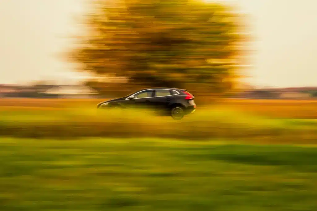 A car speeds down a country lane in Alberta.