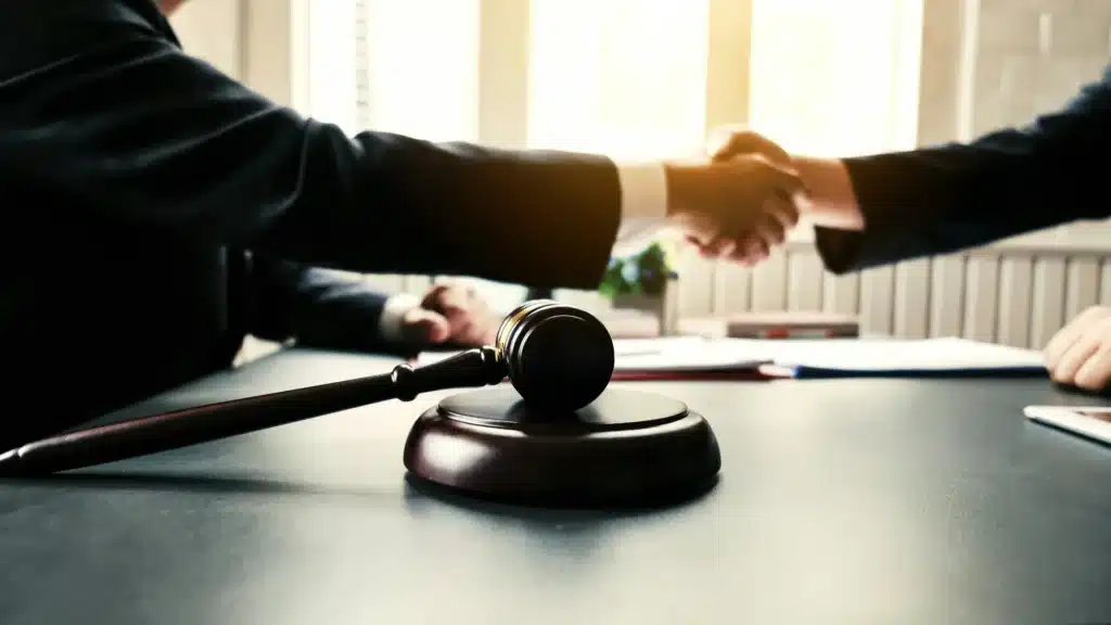 A traffic ticket expert shakes hands with a judge after settling a traffic ticket dispute.