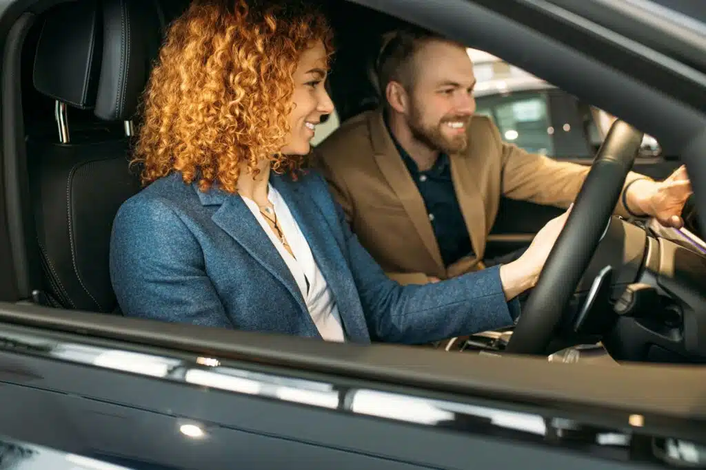 Two people smile at their dash cam footage knowing they have evidence to fight their traffic ticket.