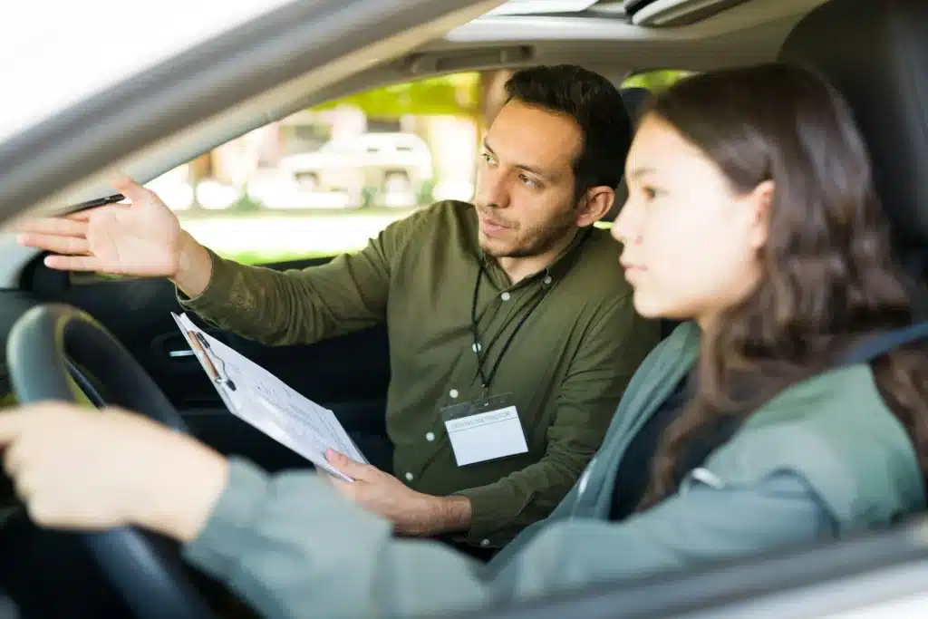 A driving instructor explains traffic ticket fines in Alberta to a new driver.